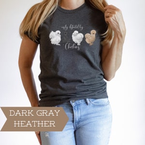 May include: A dark gray heather t-shirt with the text "easily distracted by chickens" and a graphic of four chickens.