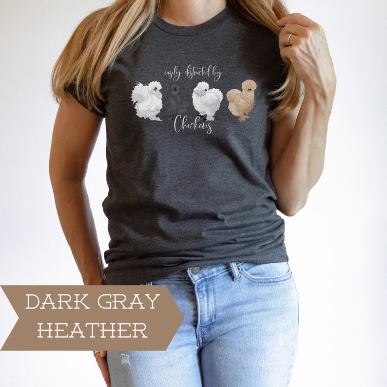 May include: A dark gray heather t-shirt with the text "easily distracted by chickens" and a graphic of four chickens.