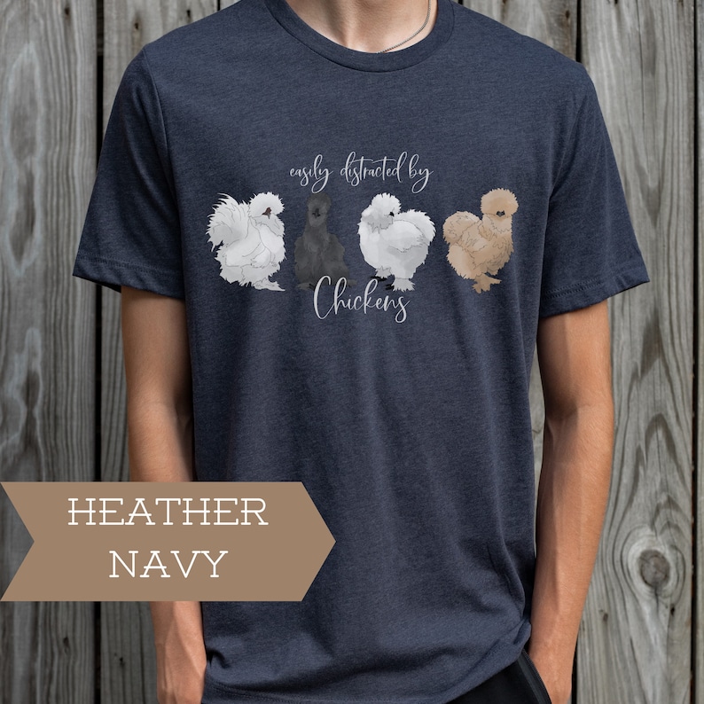 May include: A heather navy blue t-shirt with a graphic of four chickens and the text "easily distracted by chickens".