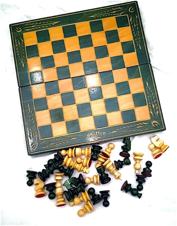 beautiful green and beige hand-inlaid wooden travel chessboard with chess / backgammon