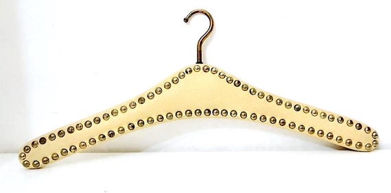 70s hanger coat hanger in wood covered in cream white leather and super glamorous rock gold studs!