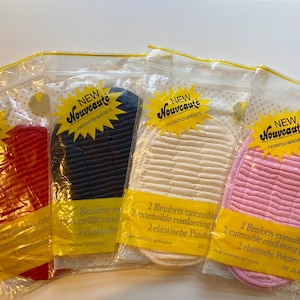 May include: Four packs of fabric elbow patches in red, navy blue, white, and pink. Each pack has a yellow label with the text "NEW Nouveauté PATENTED-BREVETE" and the text "2 Renforts extensibles 2 extensible reinforcing pieces 2 elastische Patches".