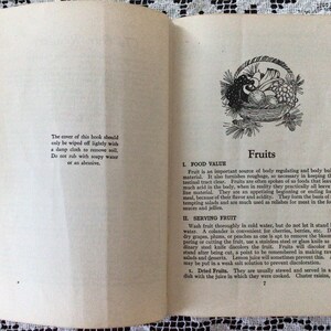 May include: A vintage book cover with a black and white illustration of a basket of fruit. The book title is "Fruits" and the text discusses the food value and serving of fruits.