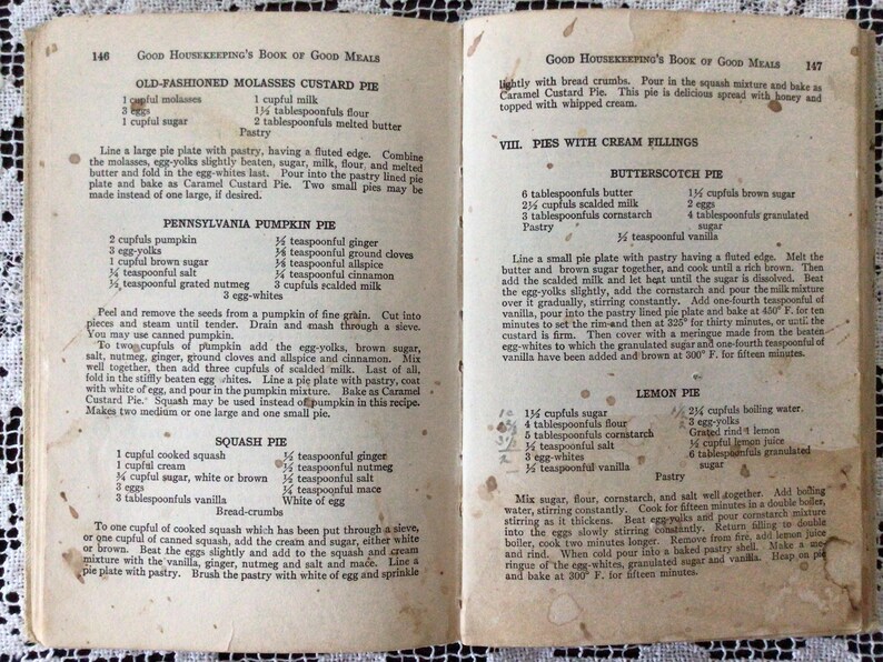 May include: A vintage cookbook with recipes for old-fashioned molasses custard pie, Pennsylvania pumpkin pie, squash pie, butterscotch pie, and lemon pie. The book is open to a page with instructions for making the pies.