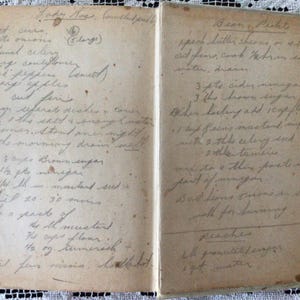 May include: An open vintage cookbook with handwritten recipes for Lady Jane's mincemeat and Bean Puddings. The recipes include ingredients like brown sugar, mincemeat, and cider vinegar.