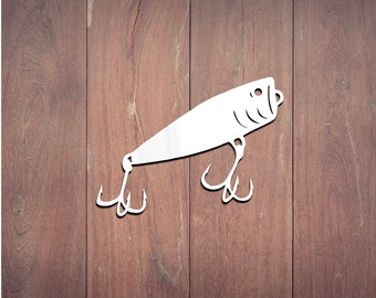 May include: A white fishing lure with two treble hooks, set against a brown wooden background. The lure has a detailed head design and a streamlined body, perfect for anglers.