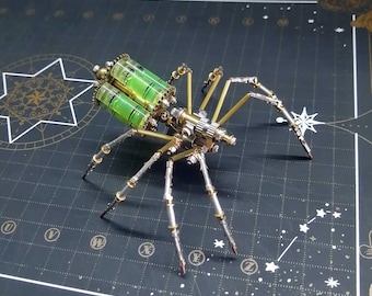 May include: A steampunk-style spider made of metal with a green and gold colour scheme. The spider has eight legs and a body with intricate details. The spider is posed on a black surface with a grid pattern.