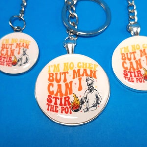 May include: Three silver keychains with round, white, and silver charms. The charms have a skeleton chef graphic and the text "I'm no chef but man can I stir the pot".