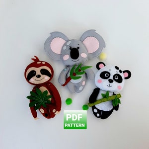 May include: Three handmade felt animal toys: a sloth, a koala, and a panda bear. The sloth is brown and red, the koala is grey, and the panda is black and white. Each animal holds a green leaf or branch. The image includes the text "PDF PATTERN".