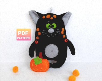 May include: A black felt cat with orange spots and green eyes holding a small orange felt pumpkin. The cat is a Halloween-themed toy and the PDF pattern is available for purchase.