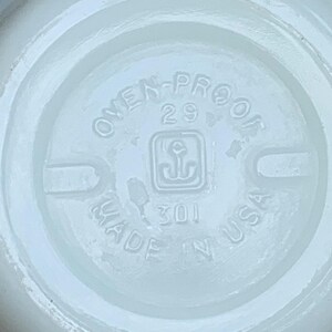 May include: White ceramic bowl with a circular inscription that reads "Oven-Proof 29 Made in USA" with an anchor symbol in the center.