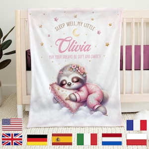 Puede incluir: Una manta de bebé rosa y blanca con una ilustración de un perezoso durmiendo. La manta tiene estrellas doradas y el texto "SLEEP WELL, MY LITTLE Olivia MAY YOUR DREAMS BE SOFT AND SWEET!"