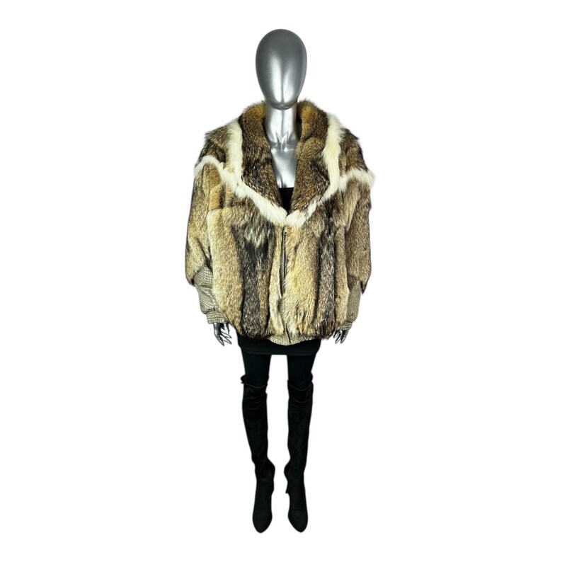 May include: A full-length shot of a mannequin wearing a fur coat. The coat is a mix of brown, tan, and cream colors. It has a wide collar and a zipper closure. The mannequin is also wearing a black skirt and black thigh-high boots.