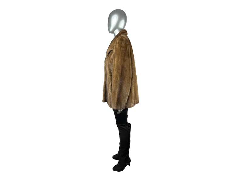 May include: A brown fur coat with a collar and long sleeves. The coat is worn on a mannequin.