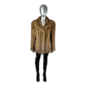 May include: A brown fur coat with a collar and a long sleeve. The coat is being worn by a mannequin.