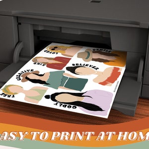May include: Printable digital download of 8 illustrated female figures with positive words like "creative", "kind", "believer", "gentle", "free", "loved", "godly". The images are being printed on a home printer.