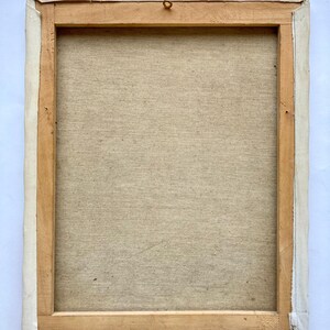 May include: A wooden frame with a canvas stretched over it. The canvas is a light beige color and has a textured surface. The frame is a light brown color and has a white border around the edge.