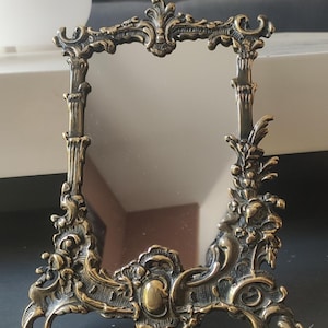 Antique rectangular dressing/table mirror with easel base in Baroque/Rocaille/Rococo style bronze with an antique gold patina. Dimensions: 22 x 17 cm