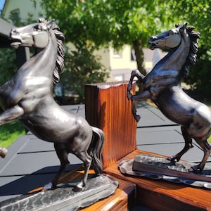 Vintage Bookends. In the shape of prancing horses, gray in color with an aged-looking patina. Gray polyresin horses on metal base