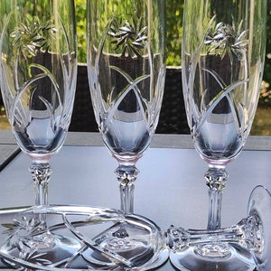 Set of 4 vintage crystal champagne flutes. Decorated with Floral/Foliage motifs. Multifaceted hexagonal foot with spike inlay.