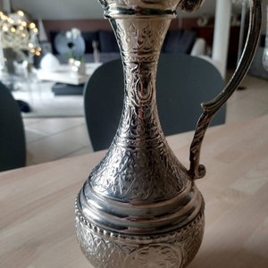 Handcrafted ewer in silver metal. Empire style. Finely engraved with flowering foliage, scrolls & a medallion Very beautiful shine