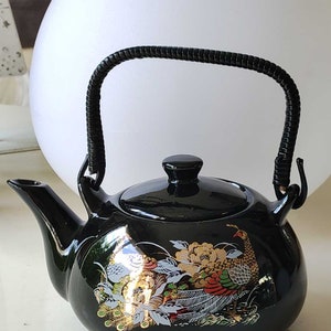 Vintage Asian teapot, peacock/floral patterns, 24-carat gold inclusions. Braided bamboo imitation handle