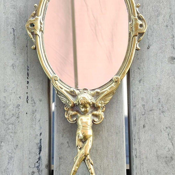 Ancien miroir face à main ovale. En bronze, Art déco. Motifs angelots/cupidon. Style Shabby chic