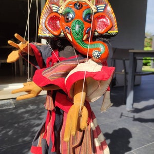 Nepalese handcrafted theatre puppet of the God Ganesh. With strings, head and 4 articulated arms. Wooden hands & feet. Height 46 cm