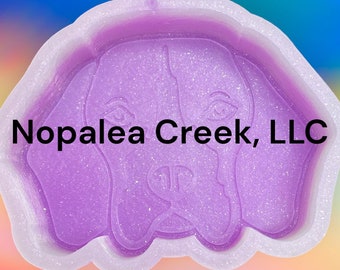 May include: Purple silicone mold with a raised design of a dog's face. The mold is for making resin crafts. The text "Nopalea Creek, LLC" is visible at the top of the mold.