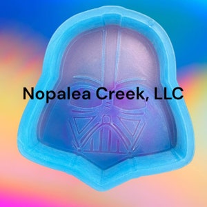 May include: A blue silicone mold shaped like Darth Vader's head. The mold is designed to create resin crafts.