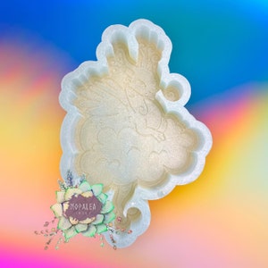 May include: White silicone mold with a detailed design of a fairy flying in the clouds. The mold is designed for crafting and creating resin art.