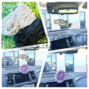 May include: A set of car air fresheners with a fish and a sunflower design. The air fresheners are hanging from the rearview mirror of a car. The image also shows a close-up of the black and white string used to make the air fresheners.