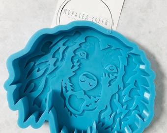May include: A blue silicone mold shaped like a dog's head. The mold is designed to create resin crafts.