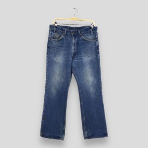 Talla 31 x 28,5 Vaqueros acampanados descoloridos azules Levi&#39;s 517 vintage, Vaqueros acampanados Levi&#39;s con lavado a la piedra, Vaqueros Levi&#39;s Usa, Pestaña naranja Levi&#39;s W31