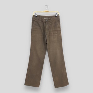 May include: Brown striped pants hanging on a wooden hanger. The pants have a straight leg and a relaxed fit.