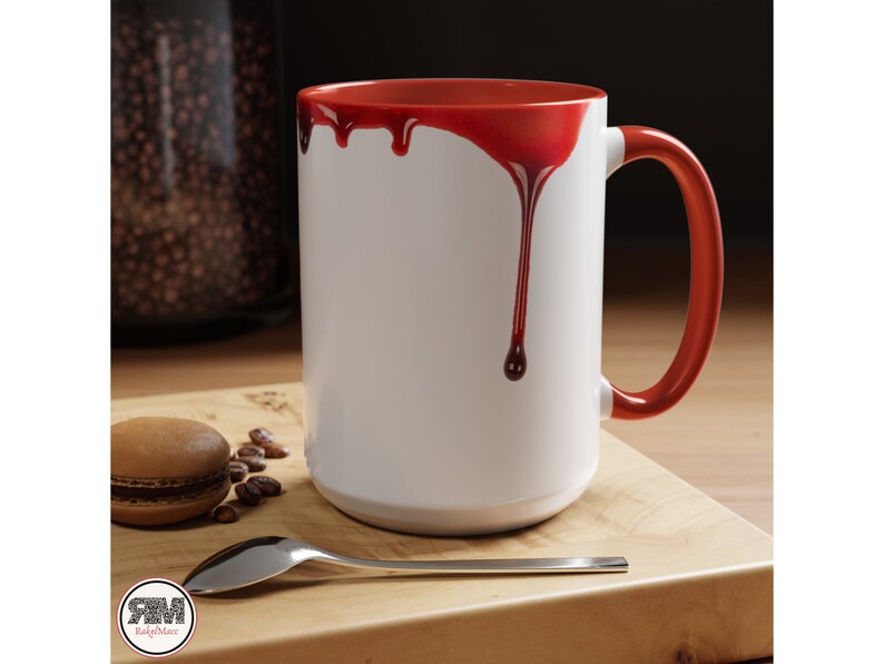 May include: White ceramic mug with a red rim and red dripping paint on the side. The mug has a handle.