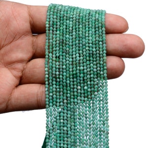 May include: A strand of green emerald beads, each bead is faceted and measures approximately 4mm in diameter.
