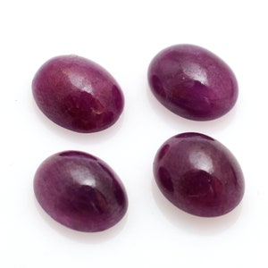 May include: Four oval-shaped purple gemstones, each with a smooth, polished surface.