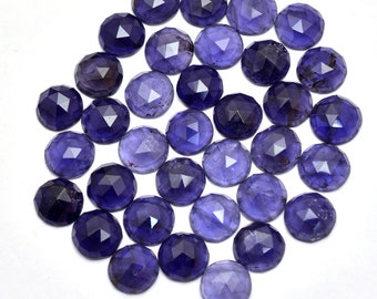 May include: A collection of 30 round, faceted, purple gemstones. The stones are arranged in a circular pattern on a white background.