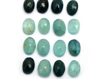 May include: Assortment of 15 oval-shaped gemstones in various shades of green and blue. The stones are faceted and have a smooth, polished finish.