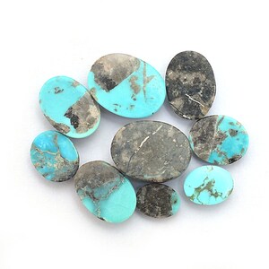 May include: A collection of eight oval-shaped turquoise stones with a blue-green color and brown and gray veining. The stones are various sizes and are arranged on a white background.