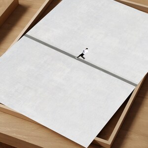 May include: An aerial view of a person running on a gray road, set against a large white background. The image is presented within a wooden tray, creating a minimalist and artistic composition.