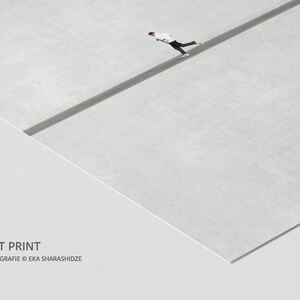 May include: Fine art print featuring a minimalist composition. A person in white and black attire is walking on a dark gray line across a light gray surface. The text "FINE ART PRINT" and the artist's name are visible.