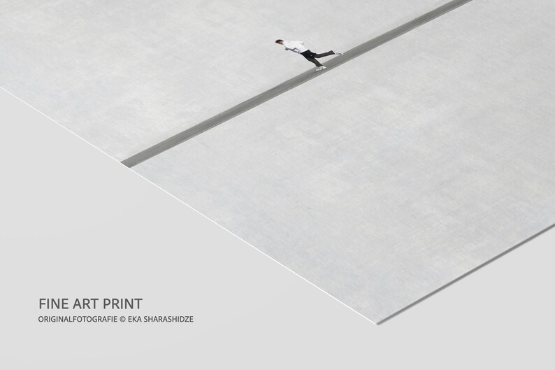 May include: Fine art print featuring a minimalist composition. A person in white and black attire is walking on a dark gray line across a light gray surface. The text "FINE ART PRINT" and the artist's name are visible.