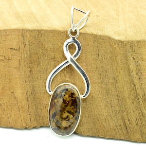 May include: A silver pendant with an oval-shaped brown and gold gemstone. The pendant has a delicate, twisted design.