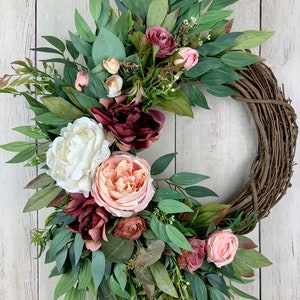 Spring summer outdoor crescent wreath for front door with long leaf eucalyptus, pink peonies, roses, Victorian grapevine wreath
