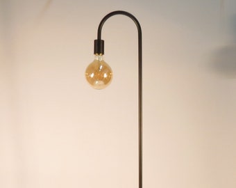 May include: Black floor lamp with a curved arm and a round base. The lamp has a single light bulb.