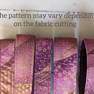 May include: Five strips of purple fabric with a gold pattern. The pattern may vary depending on the fabric cutting.