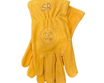 May include: A pair of yellow leather work gloves with the text "SR" and a sheep logo with the text "sheepfield" on the back of the gloves.