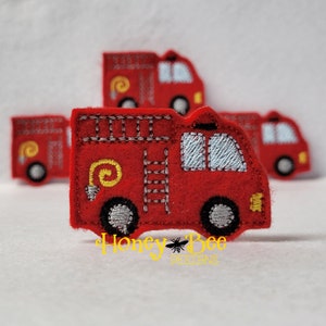 May include: Four red felt fire truck appliques with yellow details. The fire trucks have a ladder, a hose, and windows. The appliques are perfect for adding a playful touch to crafts and projects.